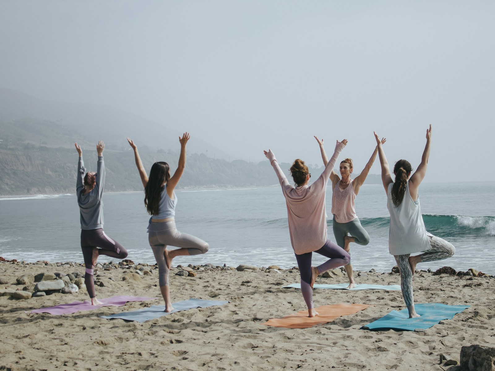 A Vinyasa Yoga class at Innerform, holding a balance pose in available light.